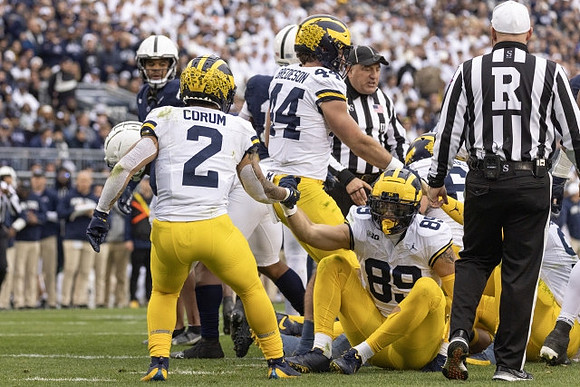 Blake Corum (2), Max Bredeson (44), and AJ Barner (89)