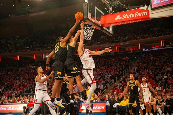 Tarris Reed Jr. (32), Olivier Nkamhoua (13), and Nimari Burnett (4)