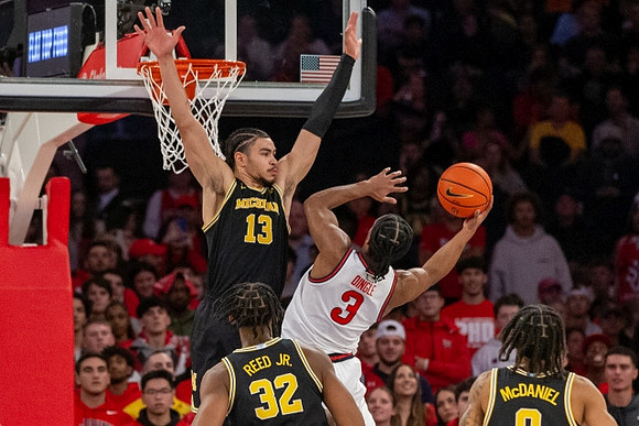 Olivier Nkamhoua (13), Tarris Reed Jr. (32), and Dug McDaniel (0)