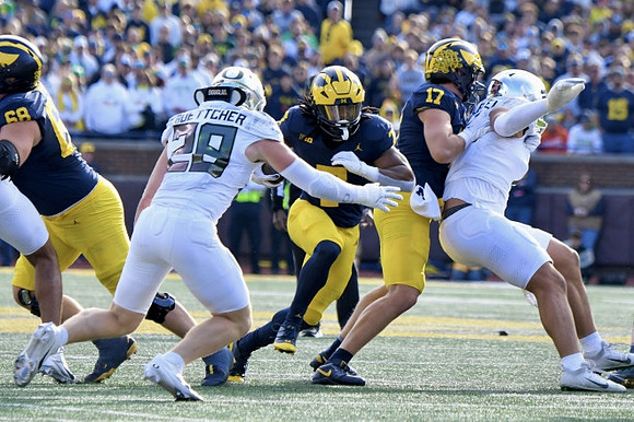 Josh Priebe (68), Donovan Edwards (7), and Marlin Klein (17)