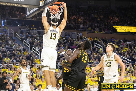 Tray Jackson (2), Olivier Nkamhoua (13), and Will Tschetter (42)