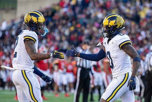 Will Johnson (2) and Mike Sainristil (0)