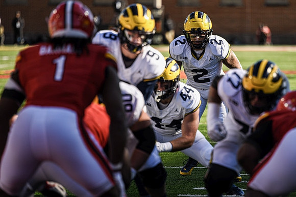 Drake Nugent (60), J.J. McCarthy (9), Max Bredeson (44), Blake Corum (2), and Trevor Keegan (77)