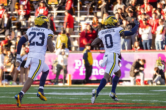 Michael Barrett (23) and Mike Sainristil (0)