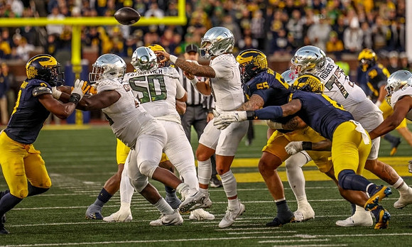 Josaiah Stewart (0), Mason Graham (55), and Derrick Moore (8)
