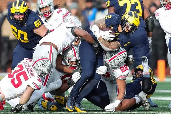 Drake Nugent (60), Blake Corum (2), LaDarius Henderson (73), and Karsen Barnhart (52)