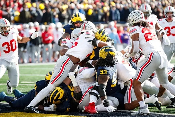 Trevor Keegan (77), Blake Corum (2), and Trente Jones (53)
