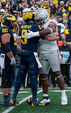 Drake Nugent (60) and J.J. McCarthy (9)