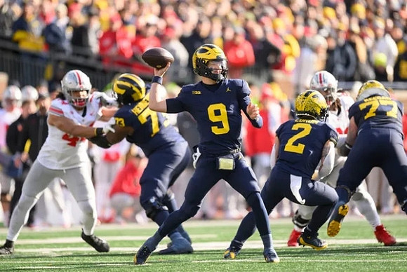 LaDarius Henderson (73), J.J. McCarthy (9), Blake Corum (2), and Trevor Keegan (77)