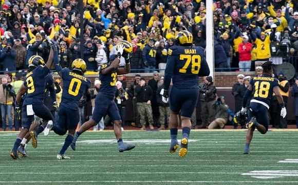 Rod Moore (9), Mike Sainristil (0), Jaylen Harrell (32), Kenneth Grant (78), and Ja'Den McBurrows (18)