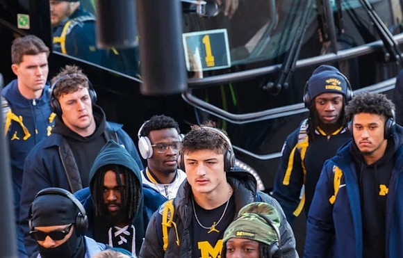 Donovan Edwards (7), Mike Sainristil (0), Colston Loveland (18), and Michigan Team