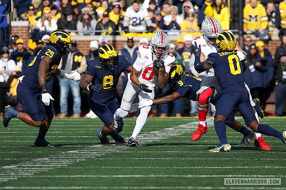 Junior Colson (25), Derrick Moore (8), Rod Moore (9), and Mike Sainristil (0)