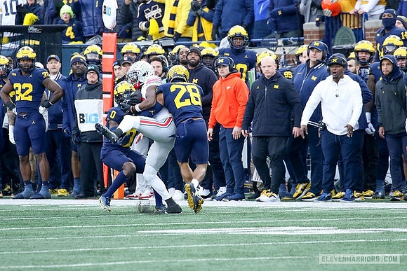 Mike Sainristil (0) and Quinten Johnson (28)