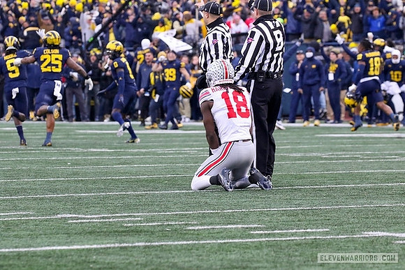 Rod Moore (9), Junior Colson (25), and Mike Sainristil (0)
