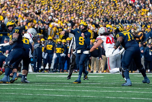 Trevor Keegan (77), Drake Nugent (60), J.J. McCarthy (9), and LaDarius Henderson (73)