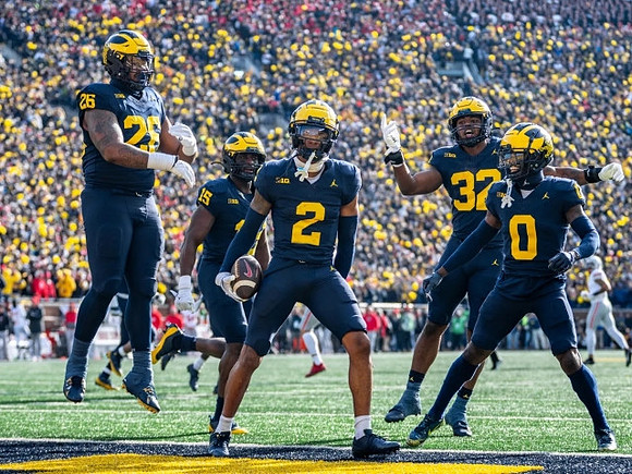 Rayshaun Benny (26), Ernest Hausmann (15), Will Johnson (2), Jaylen Harrell (32), and Mike Sainristil (0)