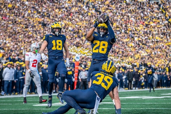 Colston Loveland (18), Joe Taylor (39), and Quinten Johnson (28)