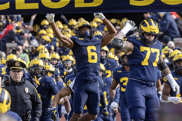 Cornelius Johnson (6), Trevor Keegan (77), and Michigan Team