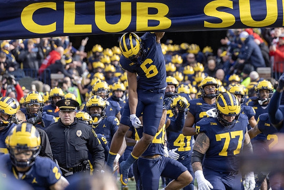 Cornelius Johnson (6), Trevor Keegan (77), and Michigan Team