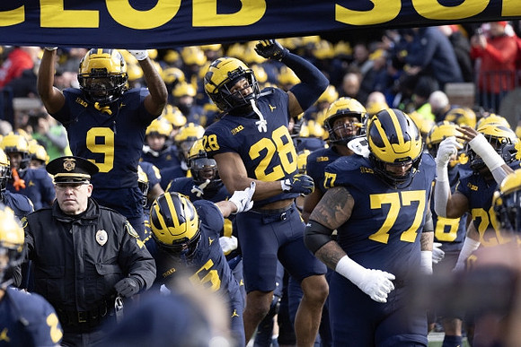 Rod Moore (9), Quinten Johnson (28), Trevor Keegan (77), and Michigan Team