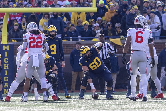 Zak Zinter (65), J.J. McCarthy (9), and Drake Nugent (60)