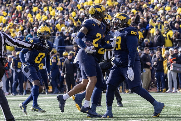 Mike Sainristil (0), Will Johnson (2), and Cam Goode (99)