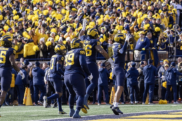 Ernest Hausmann (15), Mike Sainristil (0), Cam Goode (99), Rayshaun Benny (26), and Will Johnson (2)