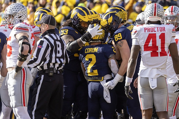Trente Jones (53), Blake Corum (2), and AJ Barner (89)