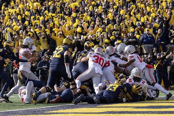 J.J. McCarthy (9), Karsen Barnhart (52), Colston Loveland (18), AJ Barner (89), LaDarius Henderson (73), and Zak Zinter (65)