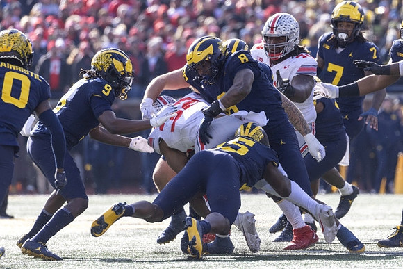 Mike Sainristil (0), Rod Moore (9), Ernest Hausmann (15), Derrick Moore (8), and Makari Paige (7)