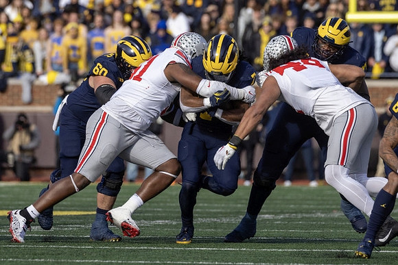 Drake Nugent (60), Donovan Edwards (7), and LaDarius Henderson (73)