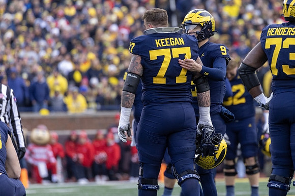 Trevor Keegan (77), J.J. McCarthy (9), and LaDarius Henderson (73)