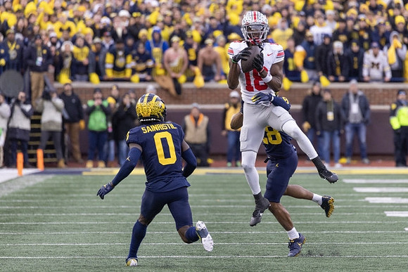 Mike Sainristil (0) and Quinten Johnson (28)