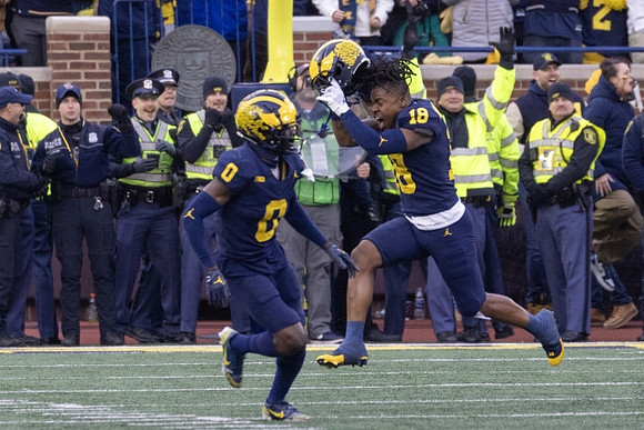 Mike Sainristil (0) and Ja'Den McBurrows (18)