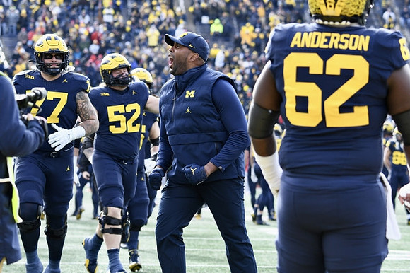 Braiden McGregor (17), Karsen Barnhart (52), Sherrone Moore, and Raheem Anderson (62)