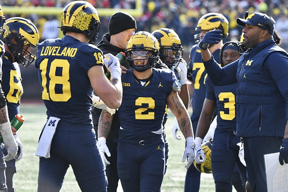 Colston Loveland (18), J.J. McCarthy (9), and Sherrone Moore