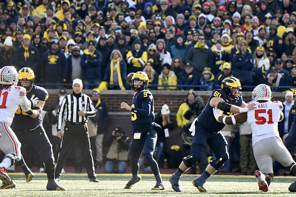Zak Zinter (65), J.J. McCarthy (9), and Drake Nugent (60)