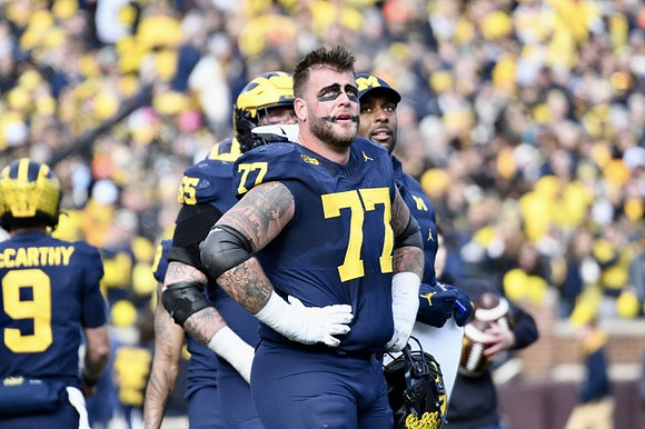 J.J. McCarthy (9), Zak Zinter (65), Trevor Keegan (77), and Sherrone Moore