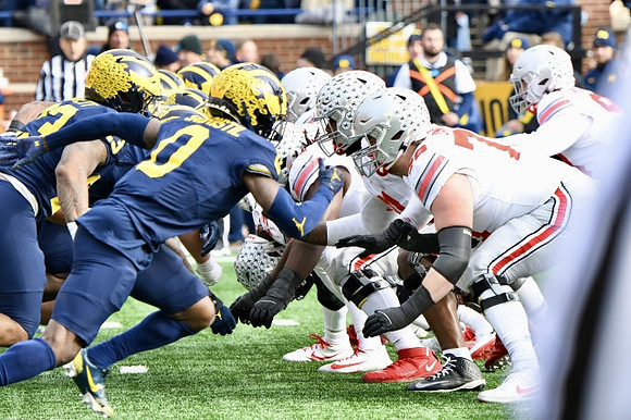 Michael Barrett (23) and Mike Sainristil (0)