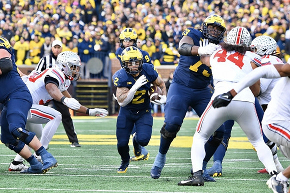 Blake Corum (2), J.J. McCarthy (9), and LaDarius Henderson (73)