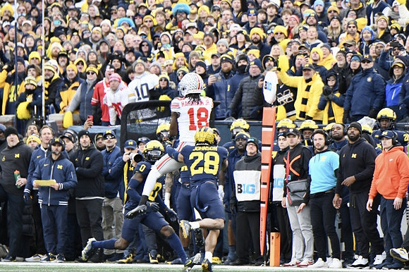 Mike Sainristil (0) and Ja'Den McBurrows (18)