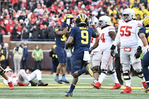 Jaylen Harrell (32), Rod Moore (9), and Michael Barrett (23)