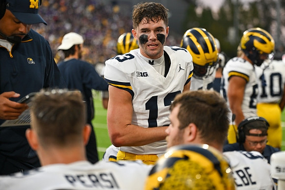 Jack Tuttle (13) and Michigan Team