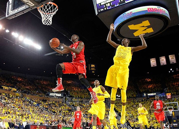 Glenn Robinson III (1), Caris LeVert (23), and Jordan Morgan (52)
