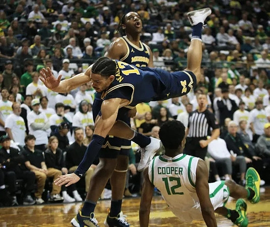 Olivier Nkamhoua (13) and Tarris Reed Jr. (32)