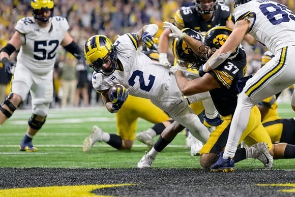Karsen Barnhart (52), Blake Corum (2), and AJ Barner (89)
