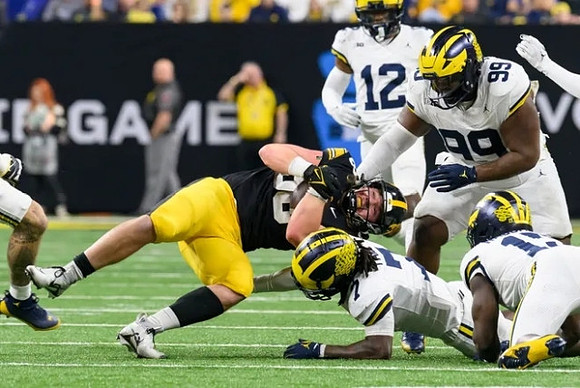 Makari Paige (7), Ernest Hausmann (15), Josh Wallace (12), and Cam Goode (99)