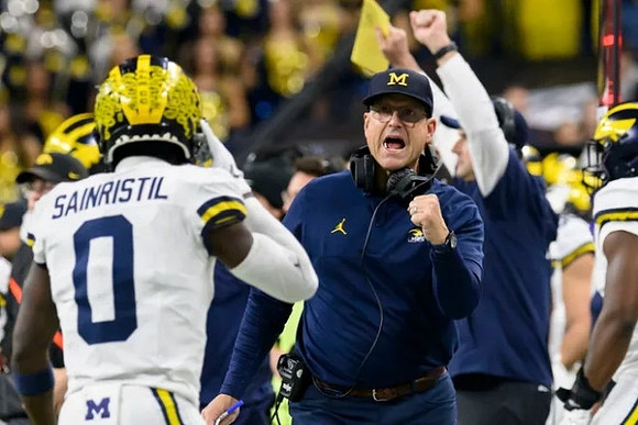 Mike Sainristil (0) and Jim Harbaugh