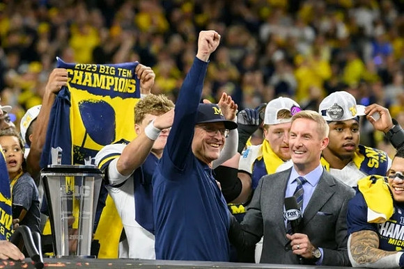 J.J. McCarthy (9) and Jim Harbaugh