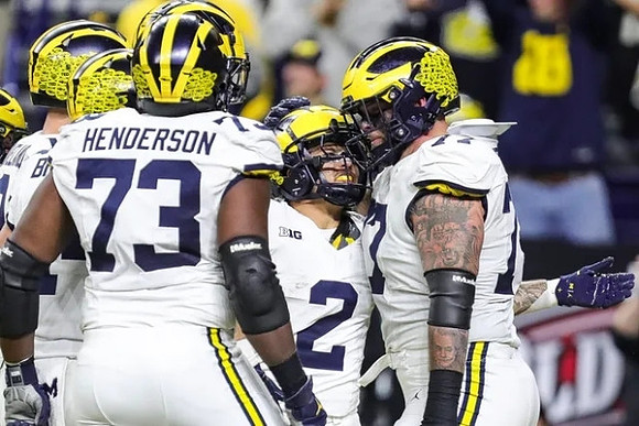 LaDarius Henderson (73), Blake Corum (2), and Trevor Keegan (77)